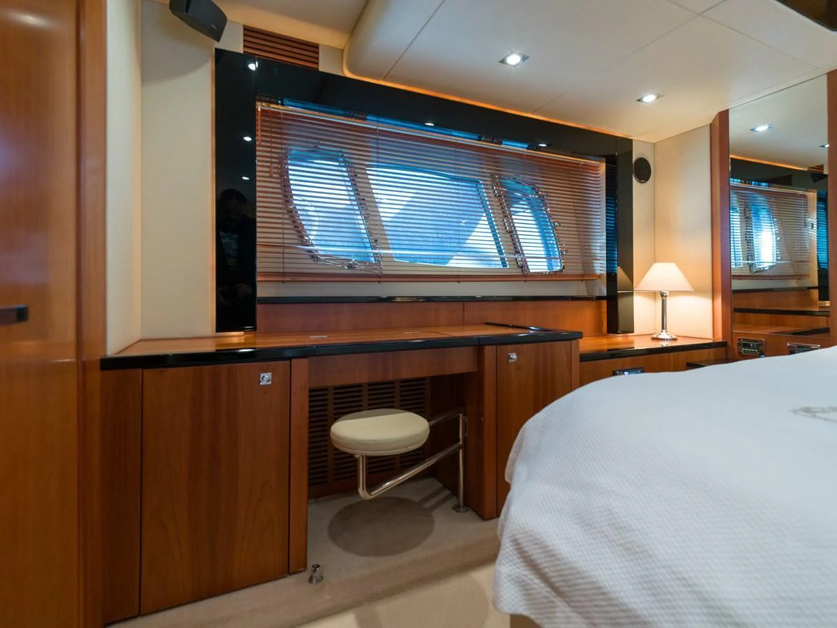 The stateroom features a sleek desk area with a window view and warm wood finishes. aboard M/Y MIEL Yacht for Sale