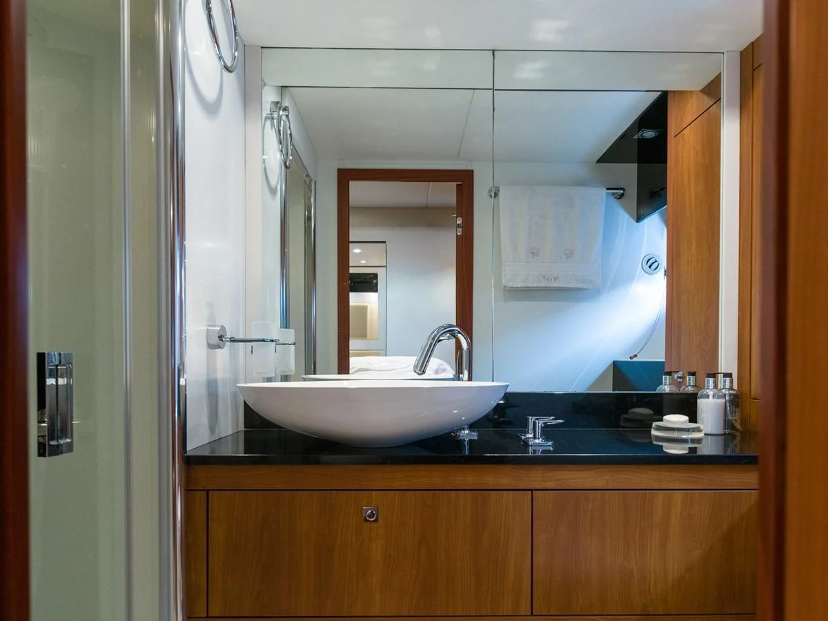The yacht's bathroom features a sleek design with a modern sink and ample counter space. aboard M/Y MIEL Yacht for Sale