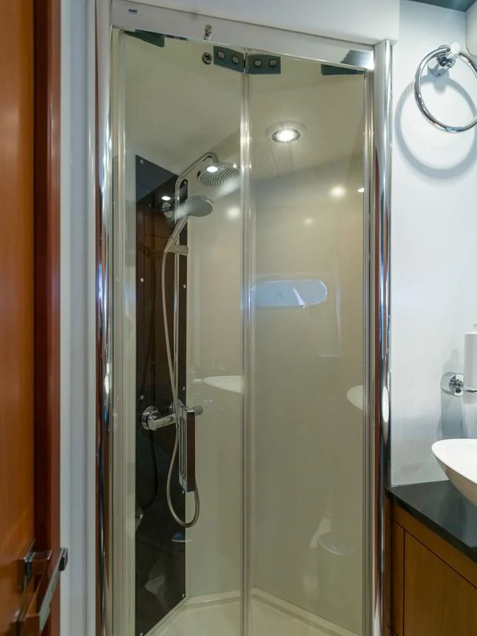 The image showcases a sleek and modern shower area within the yacht's interior. aboard M/Y MIEL Yacht for Sale