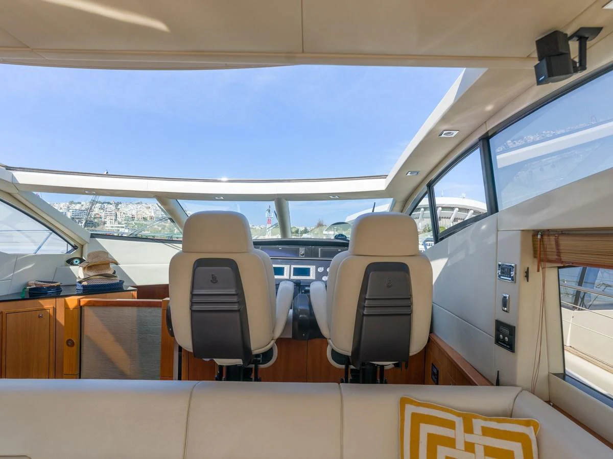 The helm area features modern seating and expansive windows for a panoramic view. aboard M/Y MIEL Yacht for Sale