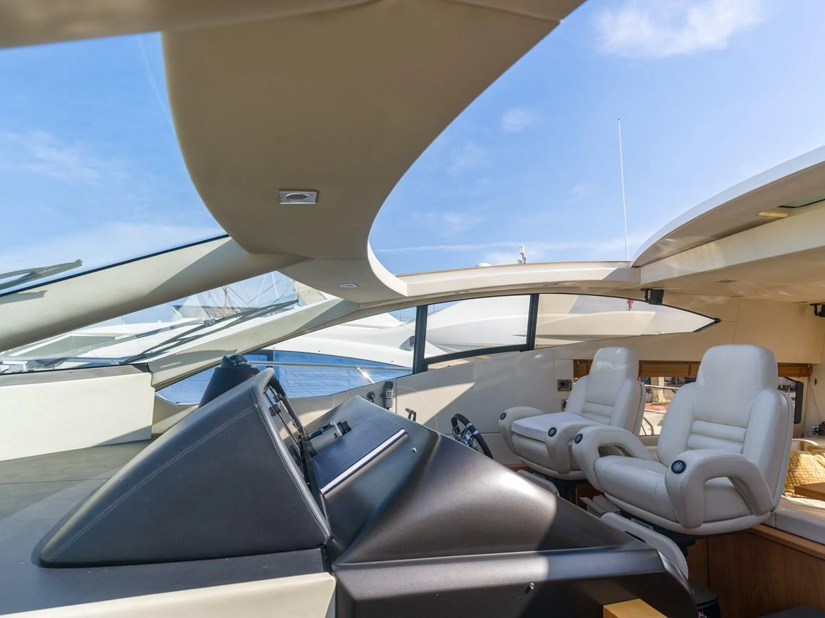 The helm area features modern controls and comfortable seating with a sleek design. aboard M/Y MIEL Yacht for Sale