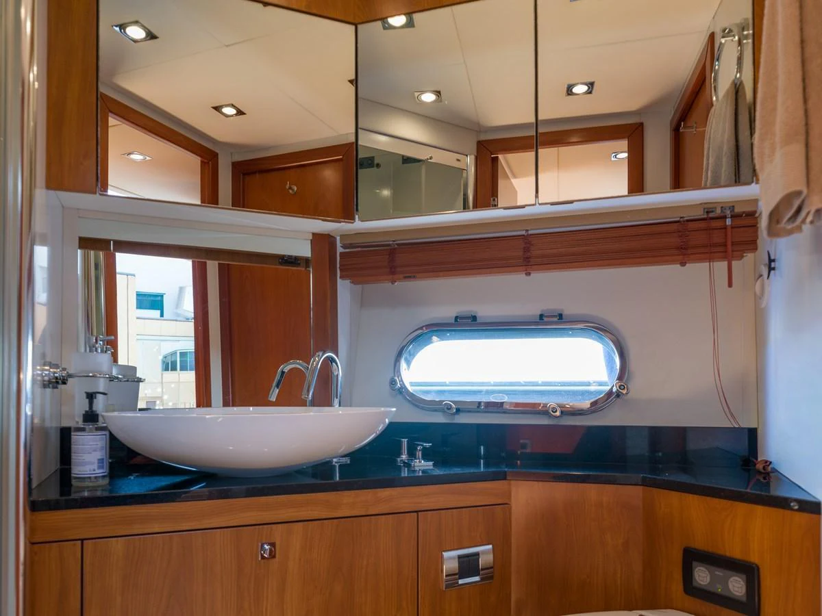 The yacht's bathroom features a sleek design with a modern sink and ample storage space. aboard M/Y MIEL Yacht for Sale