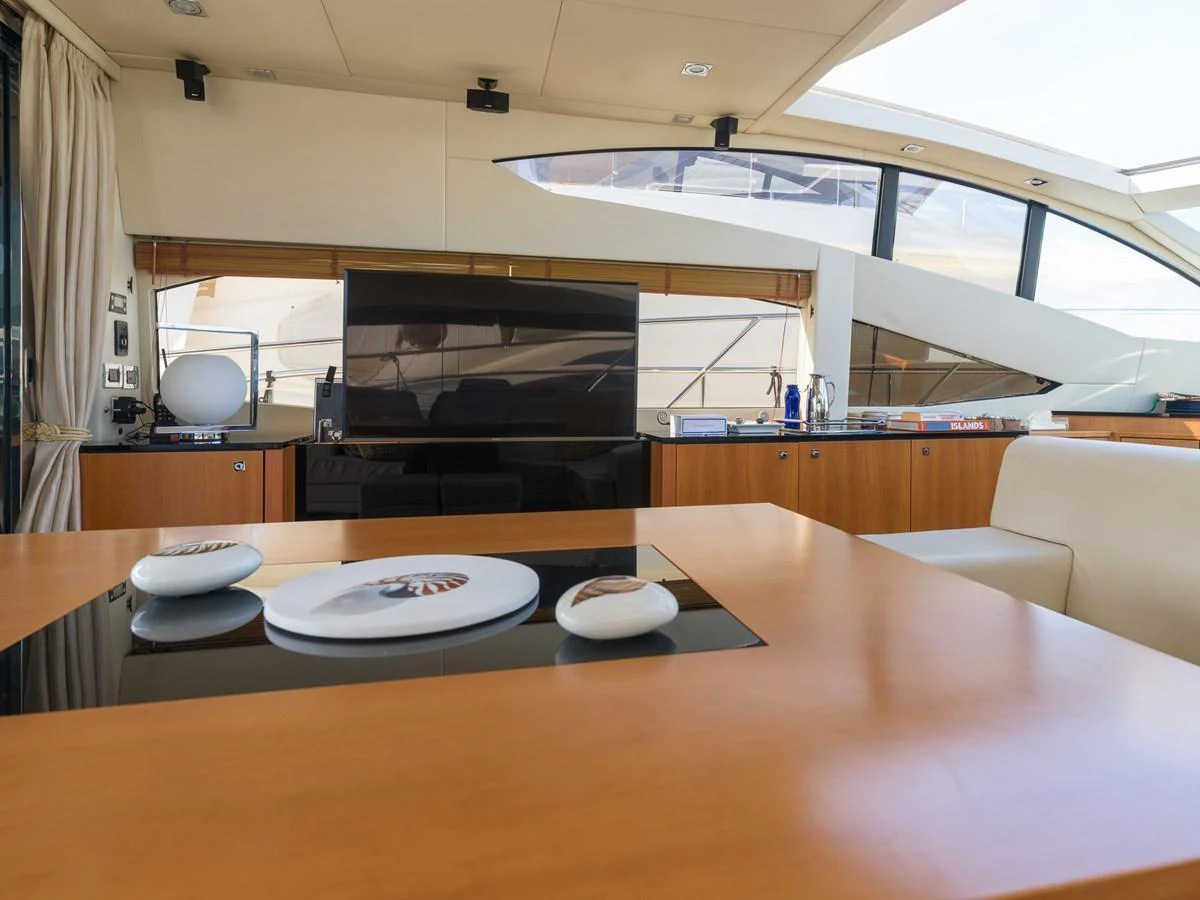 The yacht's interior features a modern and elegant dining area with a sleek table and stylish decor. aboard M/Y MIEL Yacht for Sale