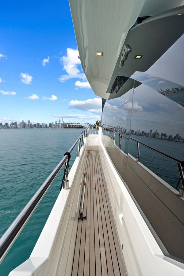 The sleek side deck of the yacht offers a stunning view of the city skyline. aboard JESSEA Yacht for Sale