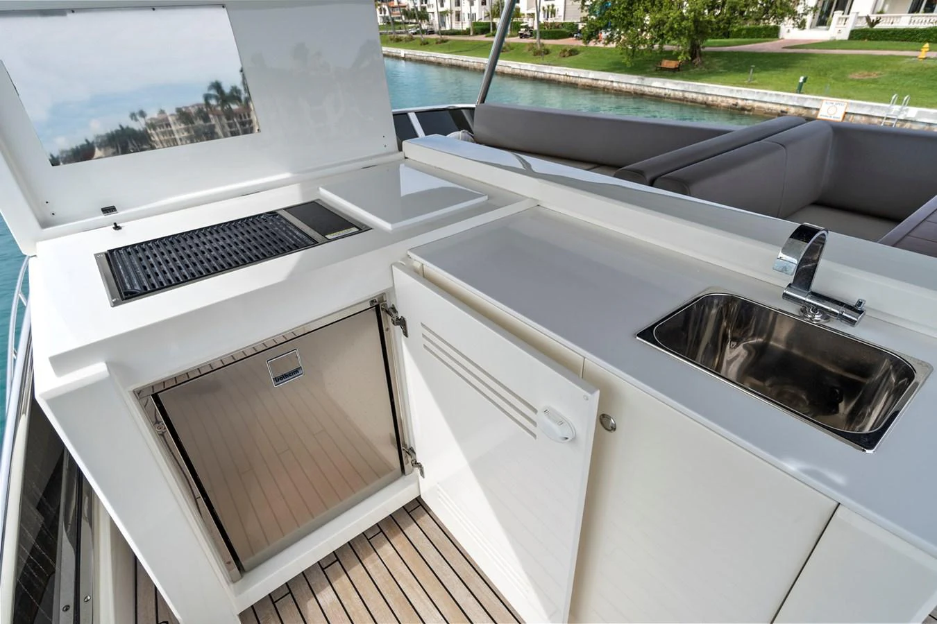 The yacht features a sleek outdoor galley with a grill, sink, and refrigerator, perfect for alfresco dining. aboard JESSEA Yacht for Sale