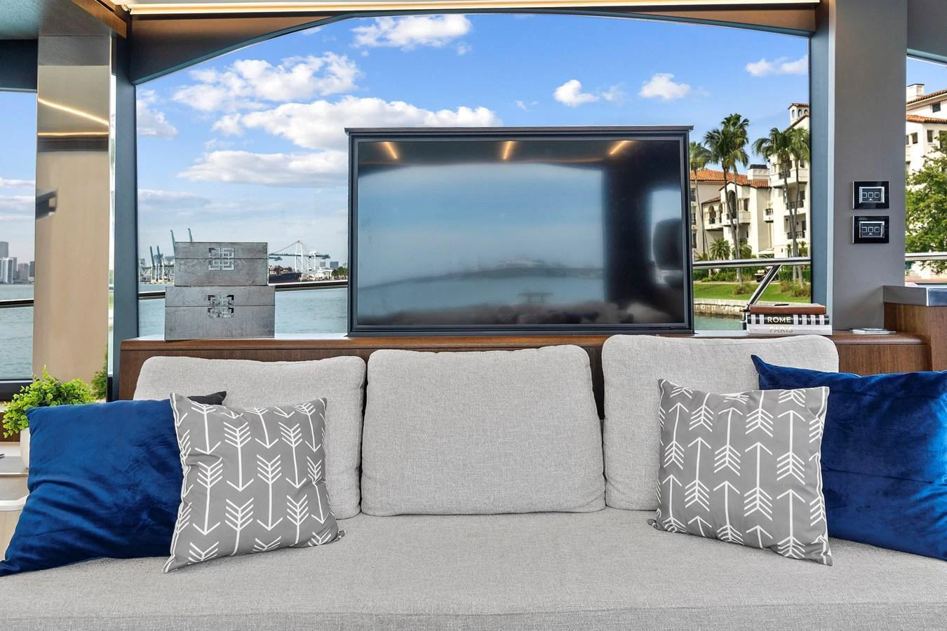 A cozy interior seating area with a large window providing a scenic view of the marina. aboard JESSEA Yacht for Sale