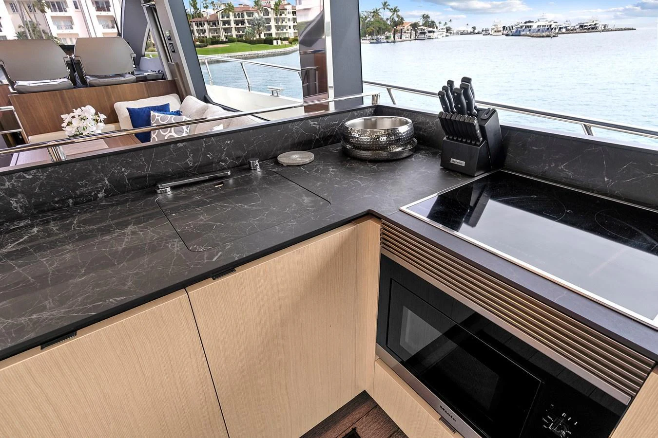 The yacht's galley features modern appliances and a sleek design with a view of the water. aboard JESSEA Yacht for Sale