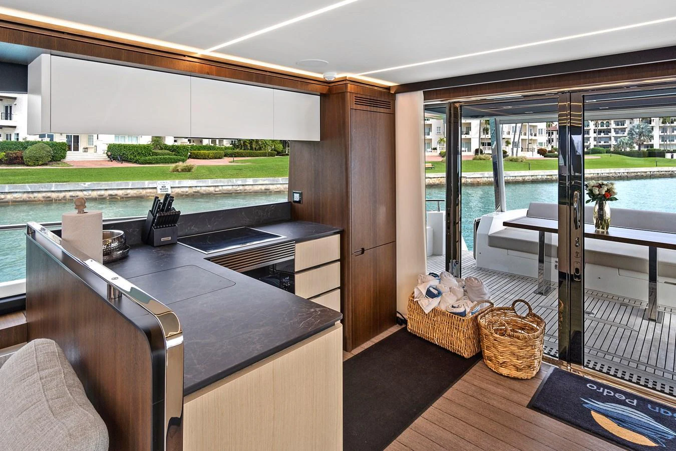 The yacht's galley features modern amenities and opens up to a spacious deck area. aboard JESSEA Yacht for Sale