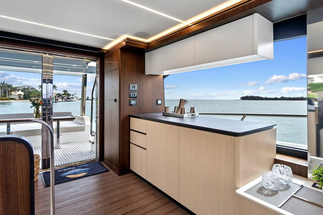 The galley offers a sleek and modern design with a view of the water through large windows. aboard JESSEA Yacht for Sale