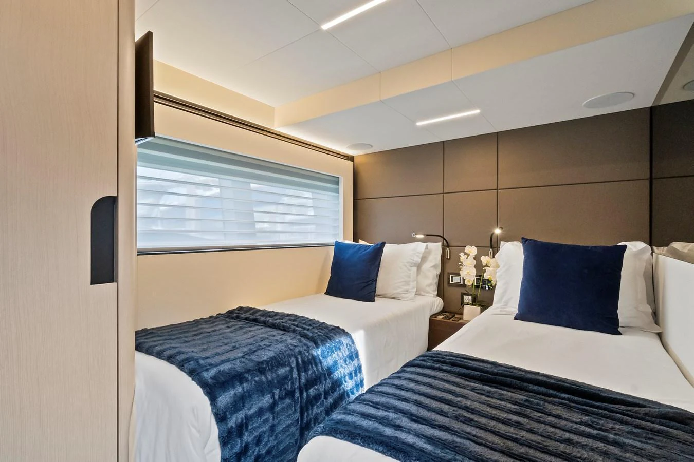 The guest stateroom features twin beds with plush bedding and modern decor. aboard JESSEA Yacht for Sale