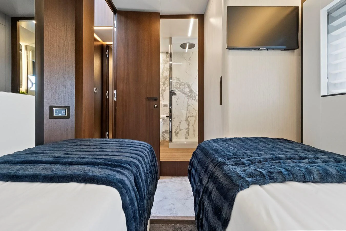 The guest stateroom features twin beds with plush bedding and a modern ensuite bathroom. aboard JESSEA Yacht for Sale