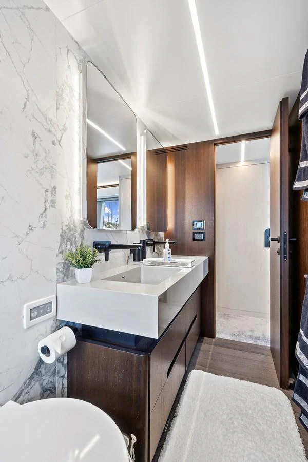 The yacht's bathroom features a sleek design with modern fixtures and elegant finishes. aboard JESSEA Yacht for Sale