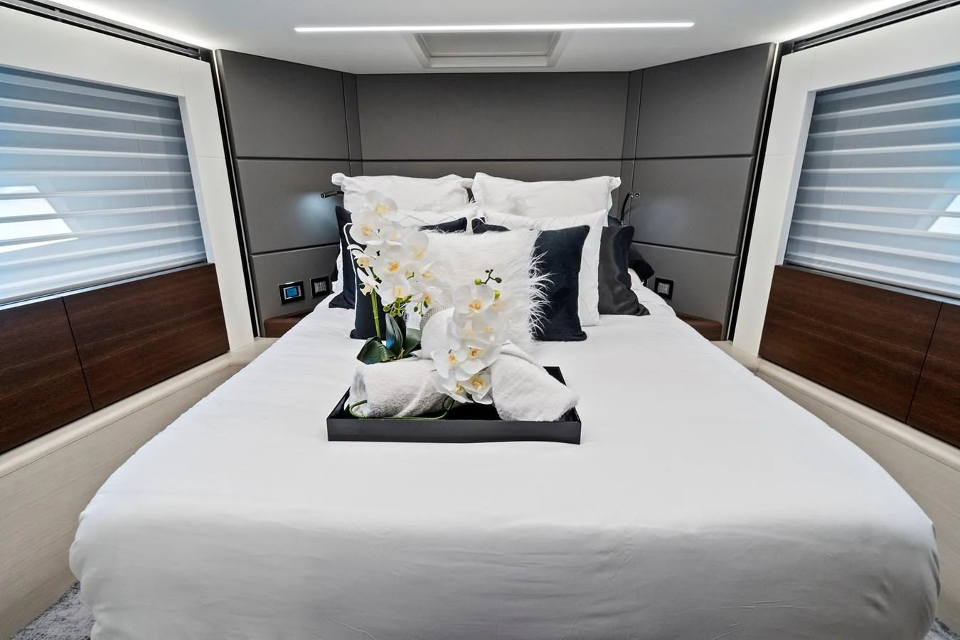 The stateroom features a plush bed with elegant decor and ample natural light. aboard JESSEA Yacht for Sale