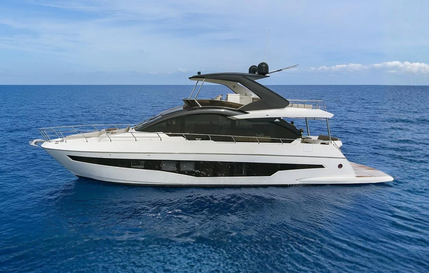 A sleek and modern yacht cruising on the open sea under a clear blue sky. aboard JESSEA Yacht for Sale