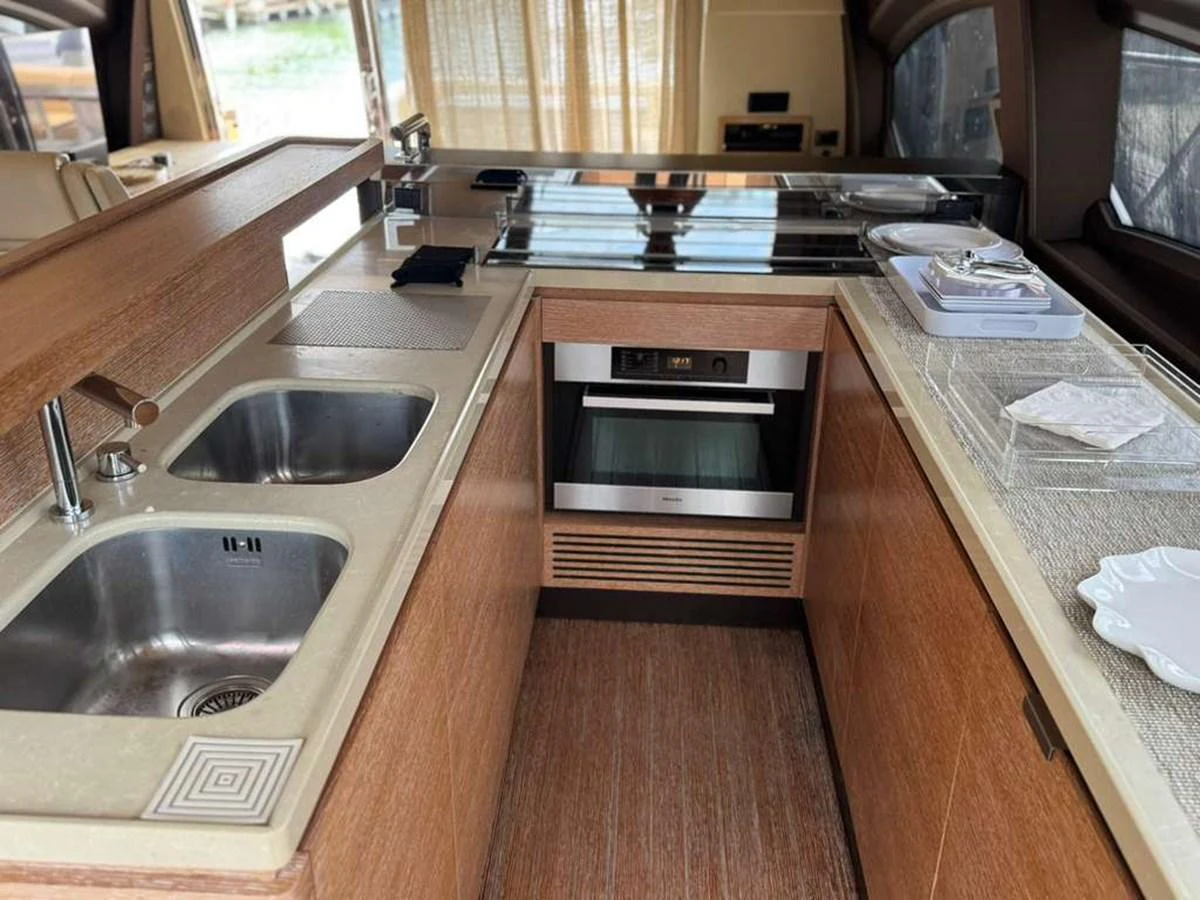 The yacht's galley is equipped with modern appliances and ample counter space, perfect for onboard culinary experiences. aboard TARKAN Yacht for Sale