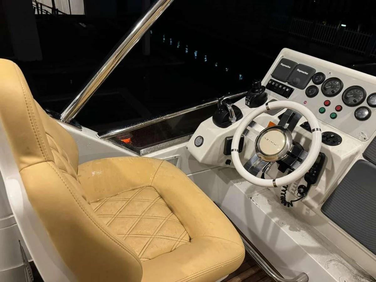 The helm features a comfortable captain's chair and a well-equipped control panel. aboard TARKAN Yacht for Sale