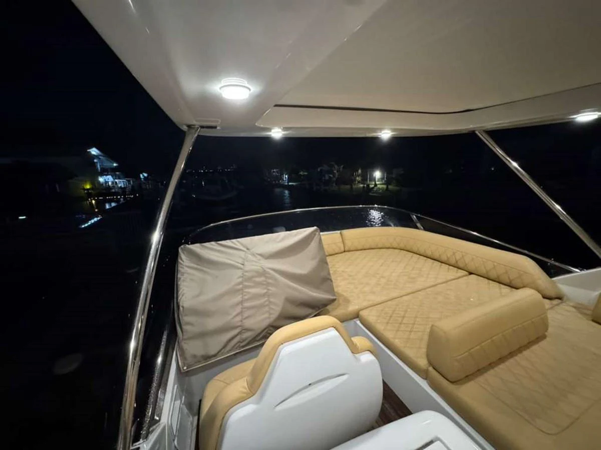 The aft deck of the yacht features comfortable seating and ambient lighting, perfect for evening relaxation. aboard TARKAN Yacht for Sale