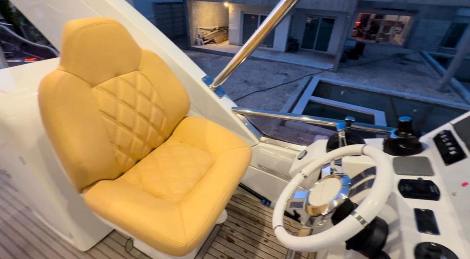The helm features a luxurious, quilted captain's chair and a modern steering console. aboard TARKAN Yacht for Sale
