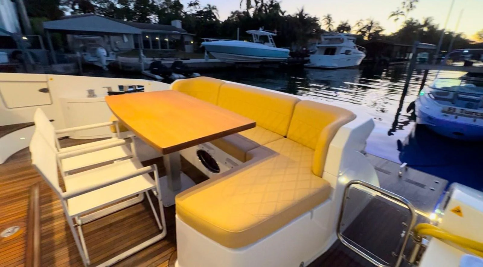 The aft deck features a comfortable seating area with a dining table, perfect for alfresco dining. aboard TARKAN Yacht for Sale
