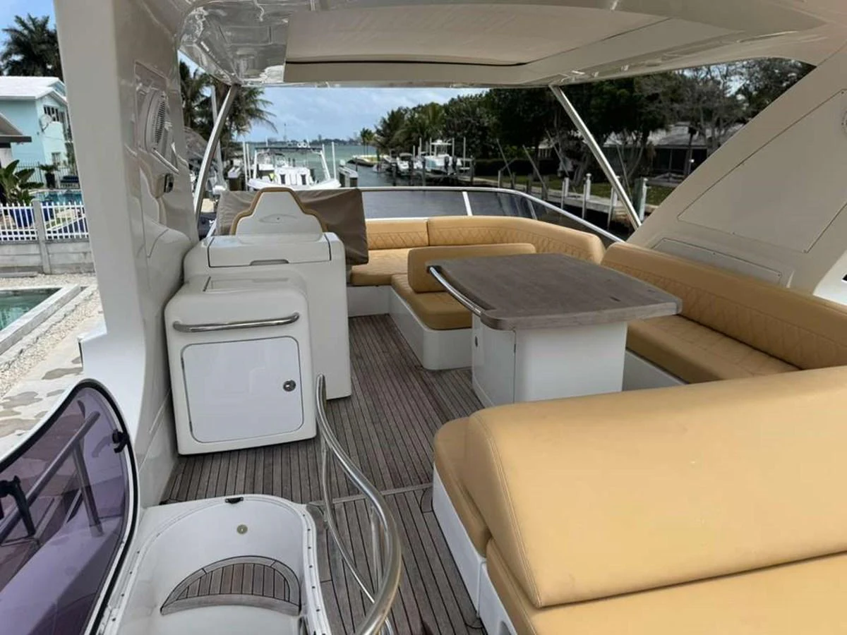 The aft deck features comfortable seating with a dining table, perfect for alfresco meals and relaxation. aboard TARKAN Yacht for Sale