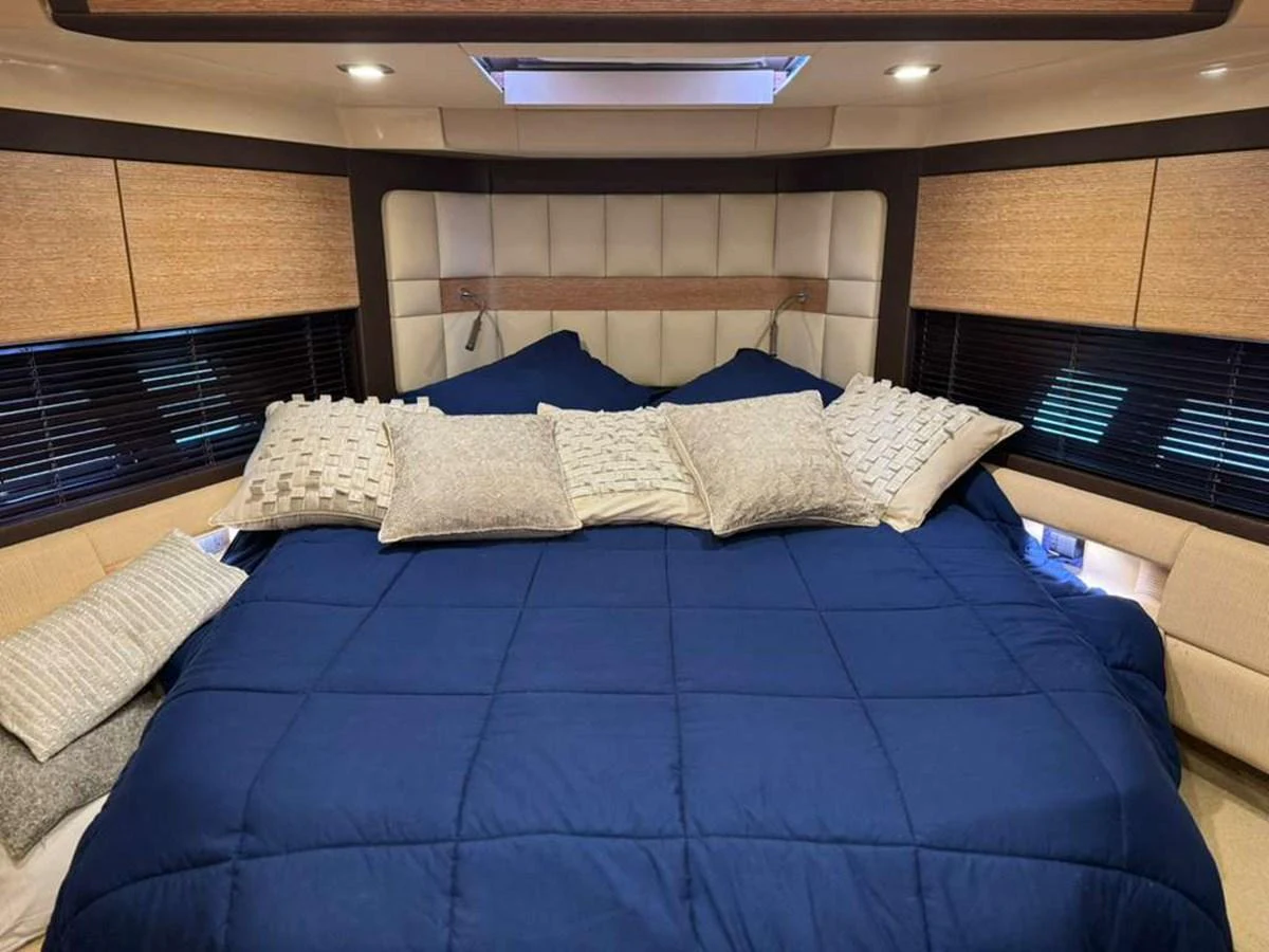 The stateroom features a plush bed with elegant bedding and ample natural light. aboard TARKAN Yacht for Sale