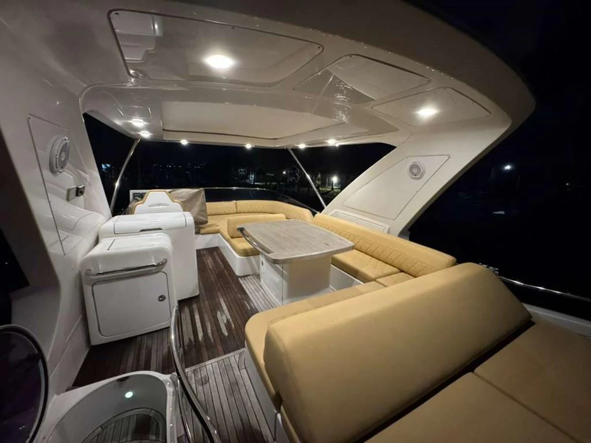 The aft deck features a spacious seating area with plush cushions and a central table, perfect for evening relaxation. aboard TARKAN Yacht for Sale