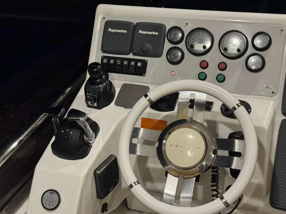 The helm features advanced navigation equipment and a sleek steering wheel. aboard TARKAN Yacht for Sale