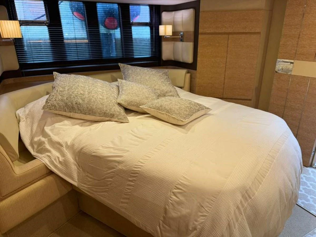 The stateroom features a plush bed with elegant bedding and soft lighting, creating a cozy and luxurious atmosphere. aboard TARKAN Yacht for Sale