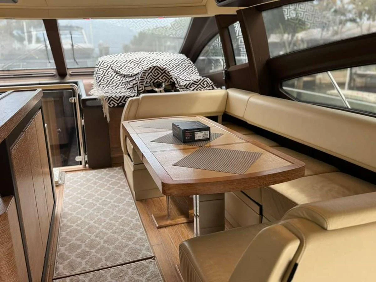 The yacht's saloon features a stylish dining area with comfortable seating and elegant wood finishes. aboard TARKAN Yacht for Sale