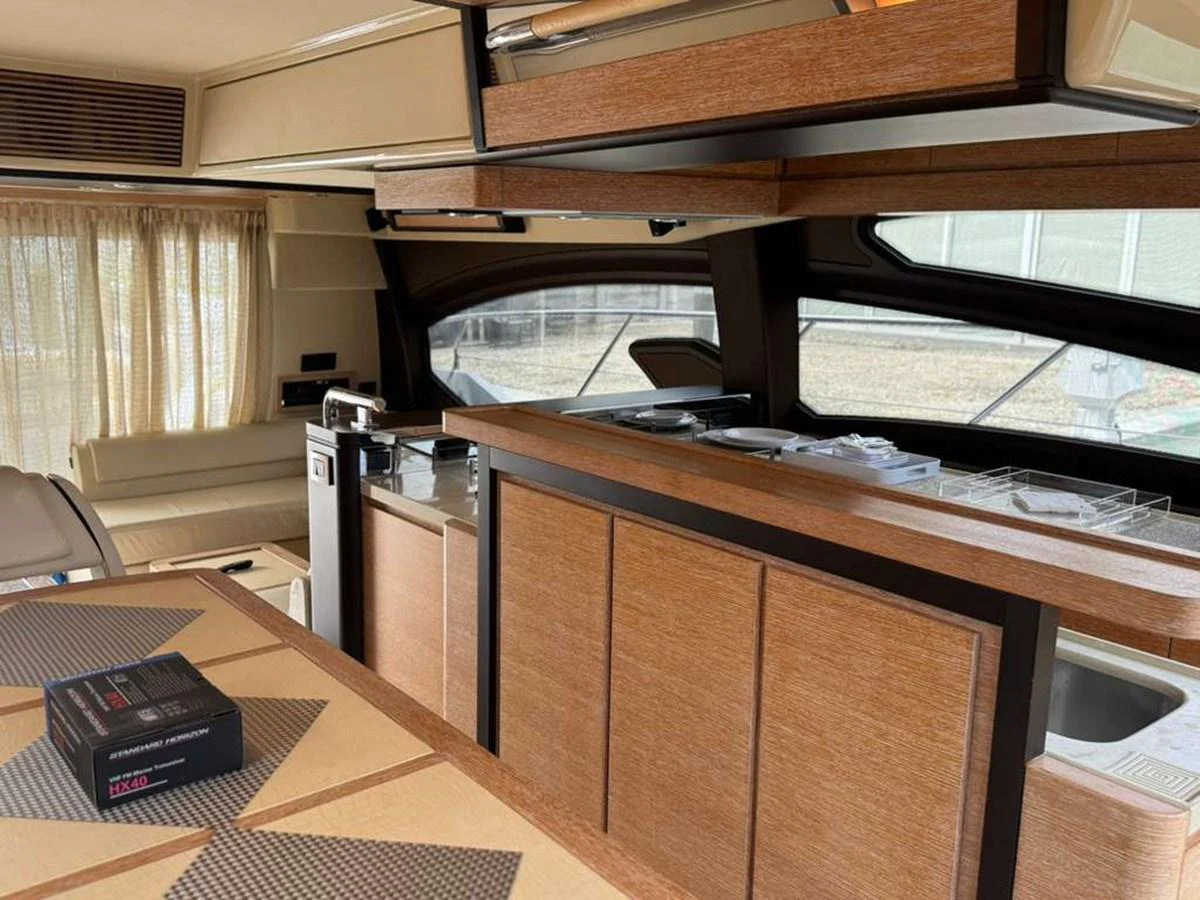 The yacht's galley features modern wood finishes and ample counter space, creating a warm and inviting atmosphere. aboard TARKAN Yacht for Sale