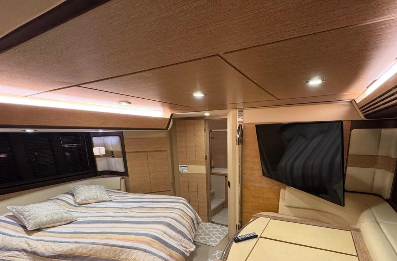 The stateroom features a cozy bed, ample storage, and a large flat-screen TV for ultimate relaxation. aboard TARKAN Yacht for Sale