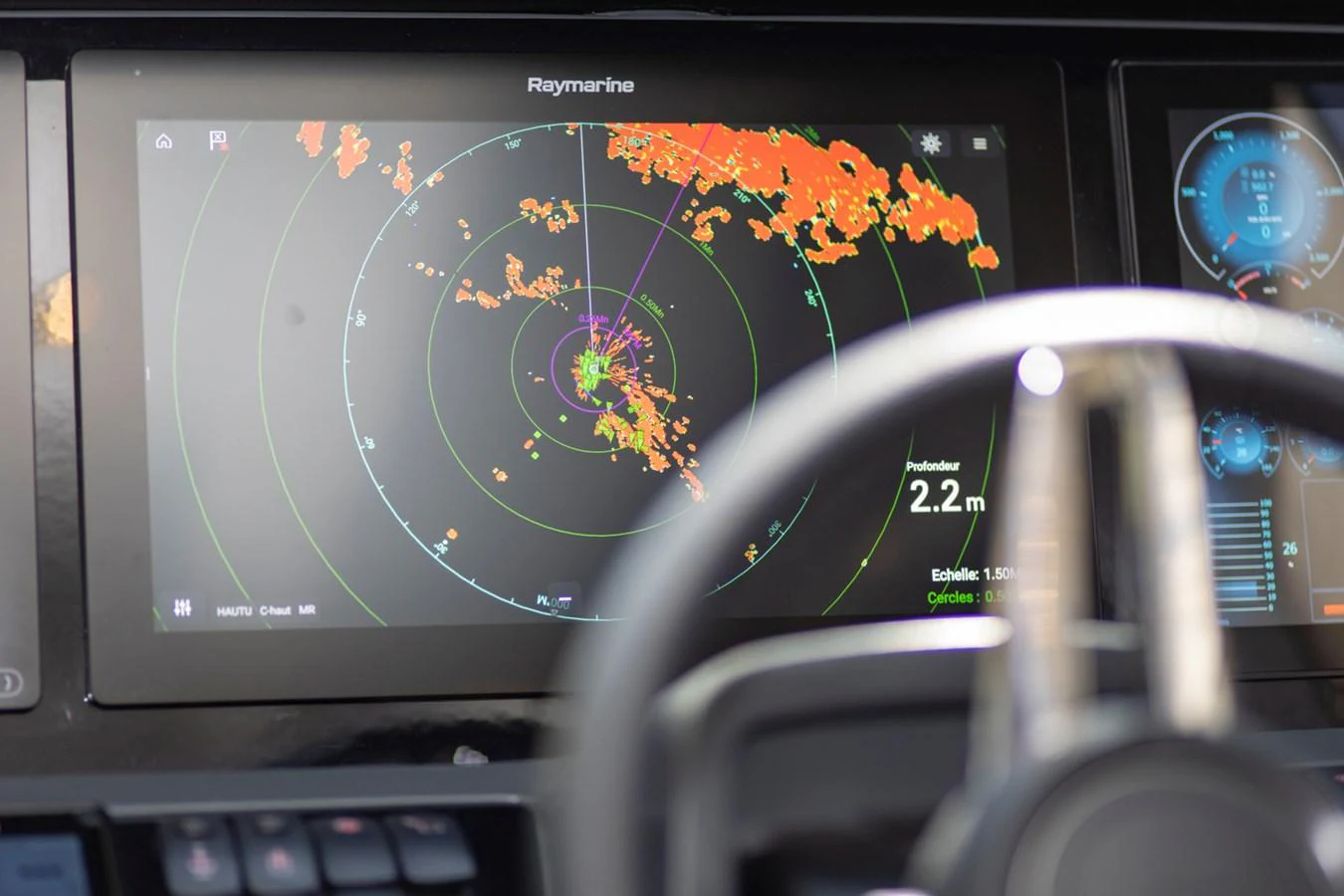 The yacht's helm features advanced navigation technology with a Raymarine radar display. aboard BK ONE Yacht for Sale