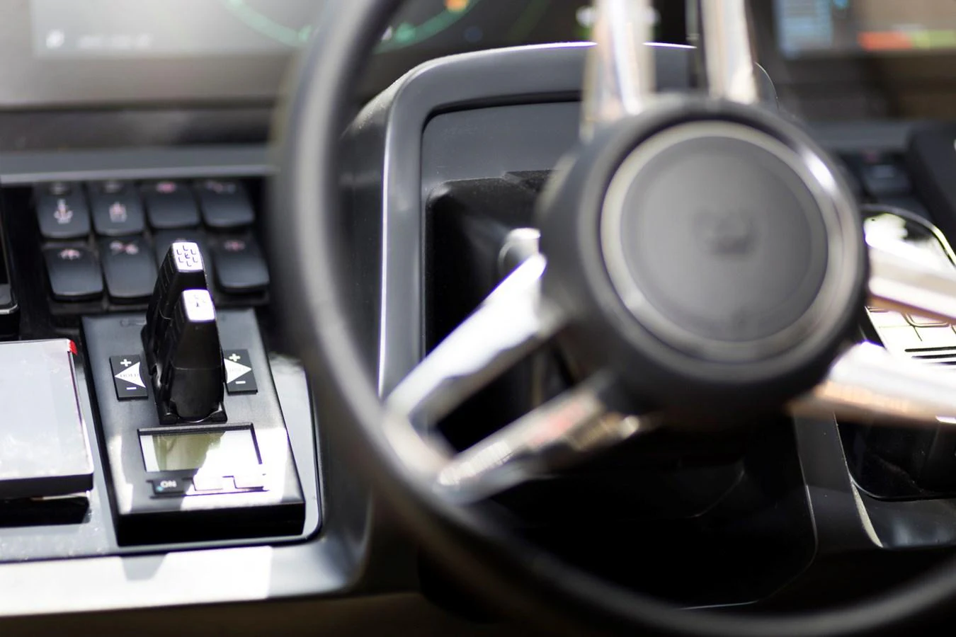A close-up view of the yacht's helm showcasing the steering wheel and control panel. aboard BK ONE Yacht for Sale