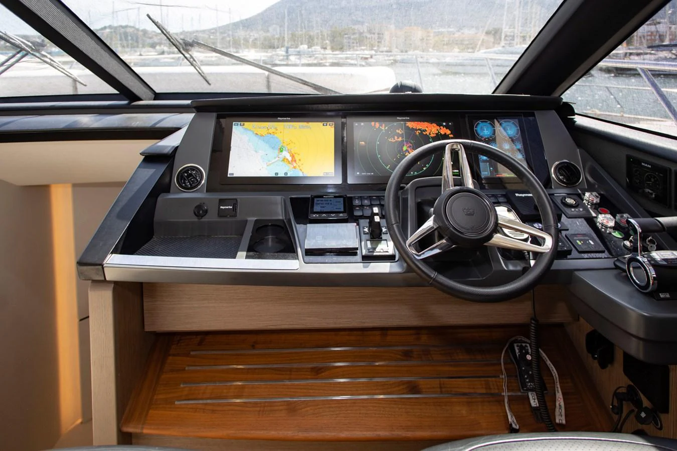 The helm station features advanced navigation equipment and a sleek steering wheel, offering a commanding view for the captain. aboard BK ONE Yacht for Sale
