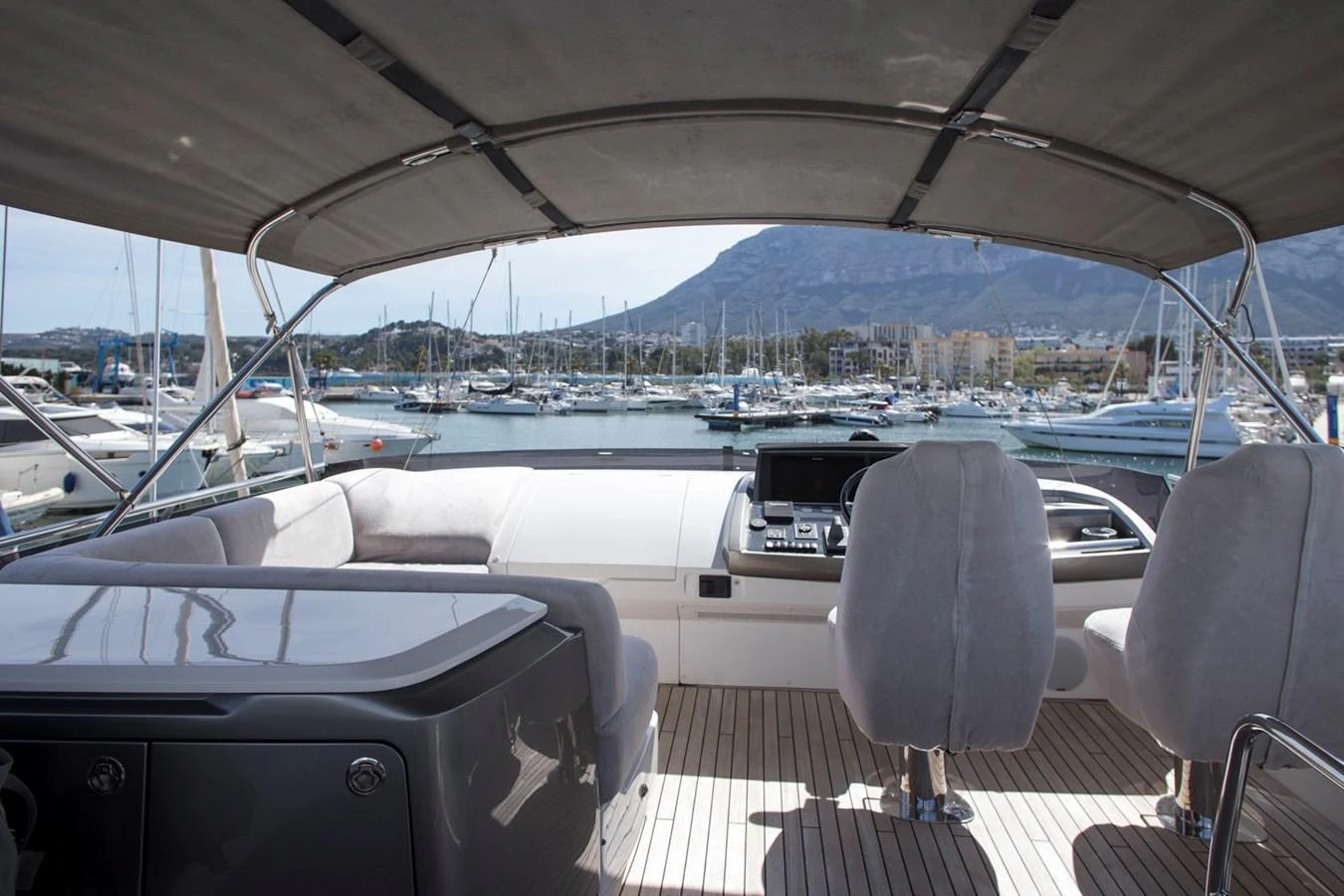The helm station offers a commanding view of the marina, with comfortable seating and modern navigation equipment. aboard BK ONE Yacht for Sale