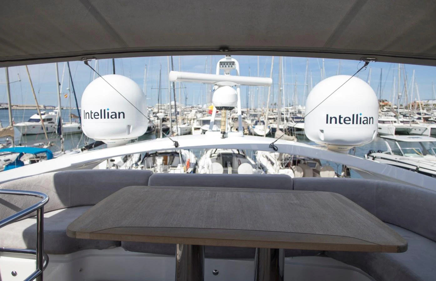 The flybridge offers a shaded area with a table and seating, perfect for enjoying the marina views. aboard BK ONE Yacht for Sale