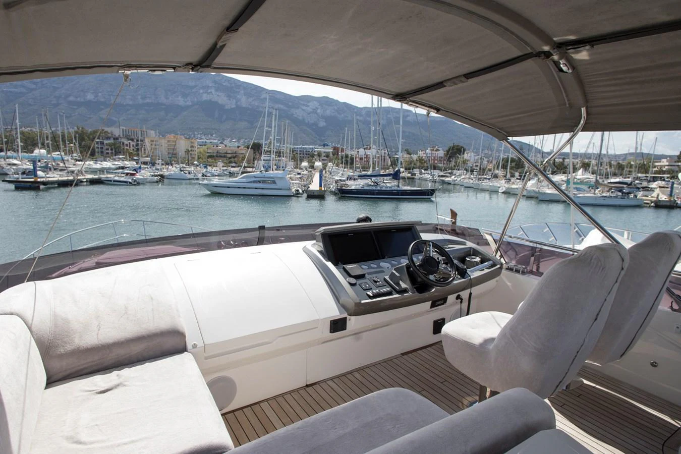 The helm station offers a commanding view of the marina with comfortable seating and modern navigation equipment. aboard BK ONE Yacht for Sale