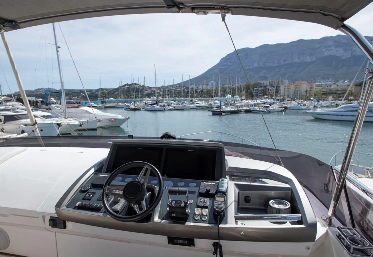The helm station offers a commanding view of the marina, equipped with modern navigation instruments. aboard BK ONE Yacht for Sale