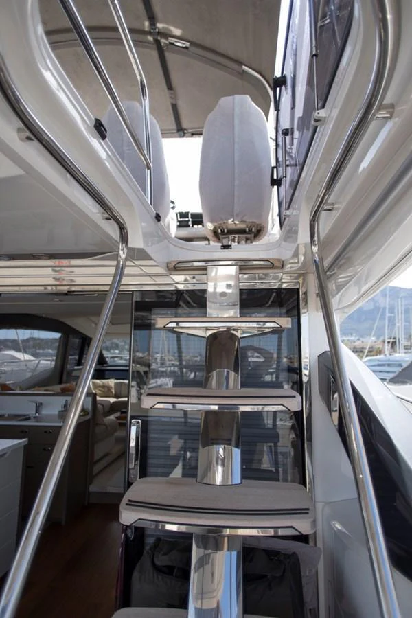 A sleek staircase leads to an upper deck, showcasing modern design and luxurious materials. aboard BK ONE Yacht for Sale
