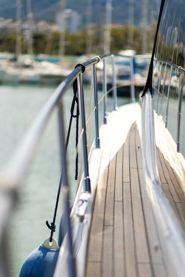 A close-up view of the yacht's side deck with polished railings and a fender hanging over the side. aboard BK ONE Yacht for Sale