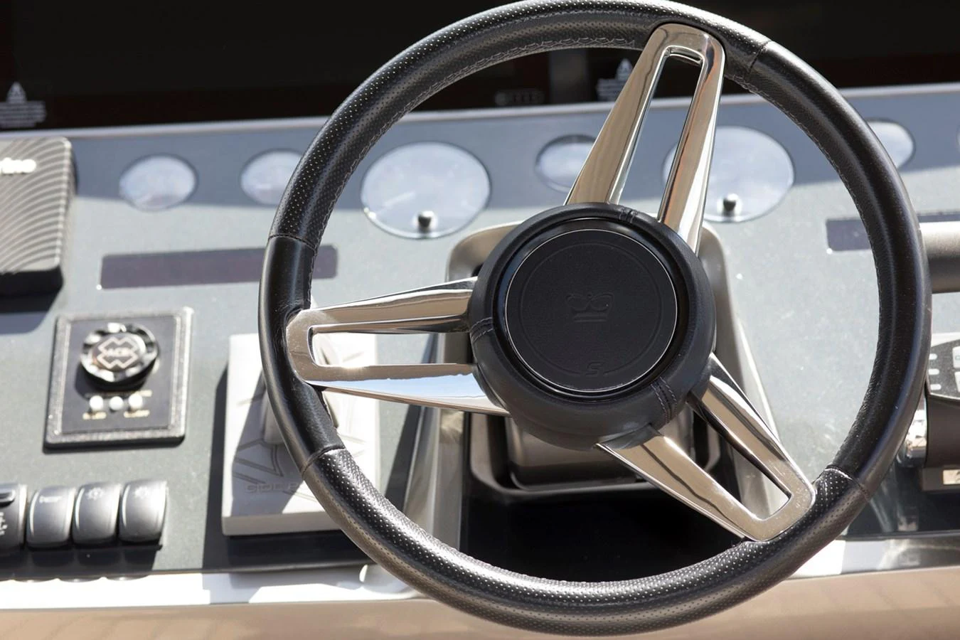 A close-up view of the yacht's helm showcasing the steering wheel and control instruments. aboard BK ONE Yacht for Sale
