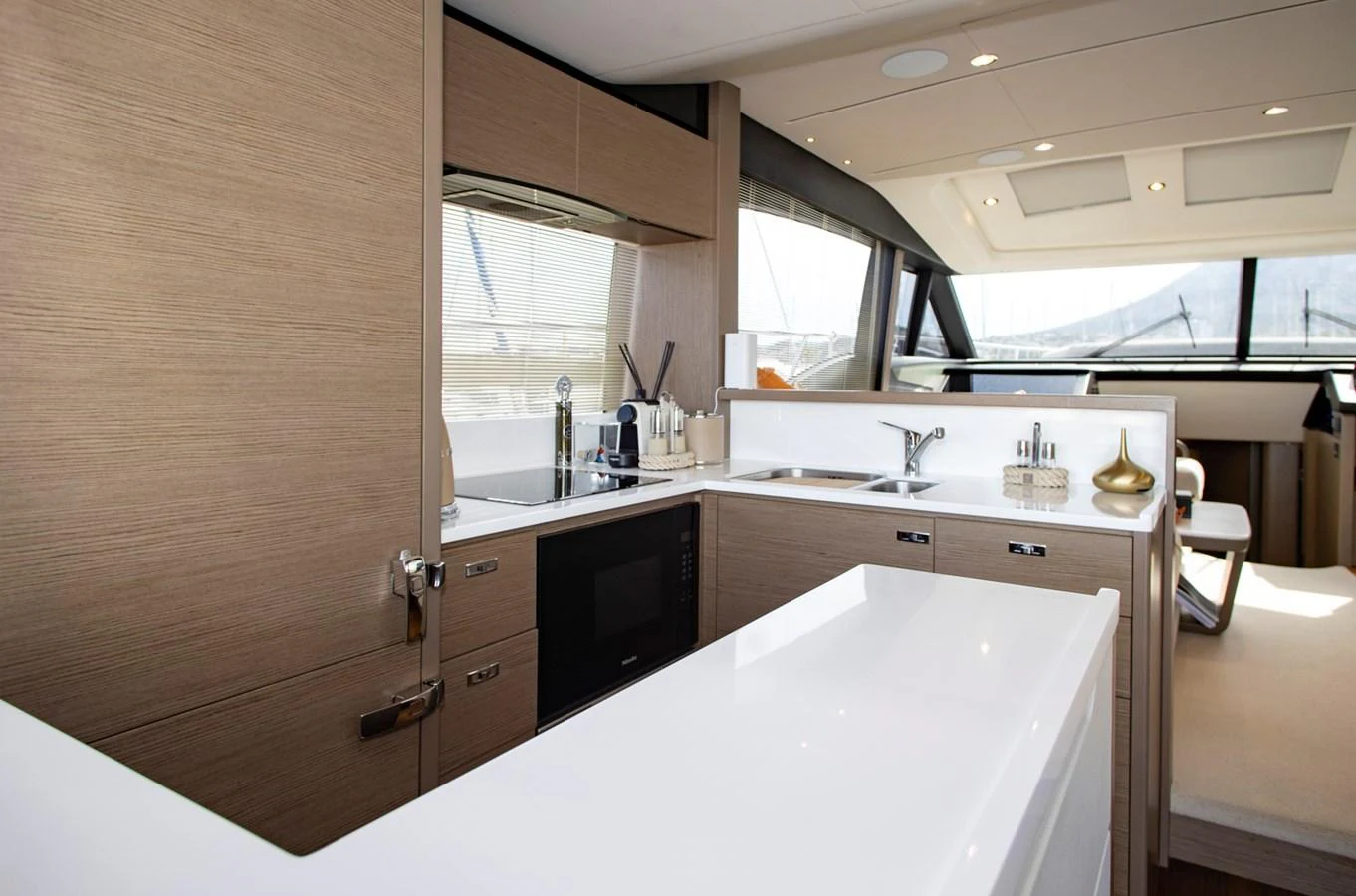 The yacht's galley is modern and well-equipped, featuring sleek cabinetry and ample counter space. aboard BK ONE Yacht for Sale