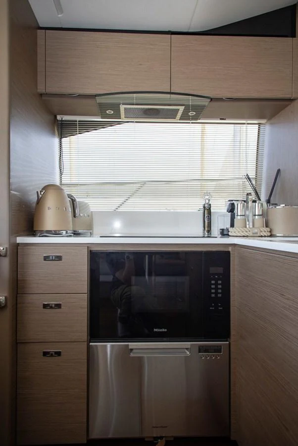 The yacht's galley is equipped with modern appliances and sleek cabinetry, offering a functional and stylish cooking space. aboard BK ONE Yacht for Sale