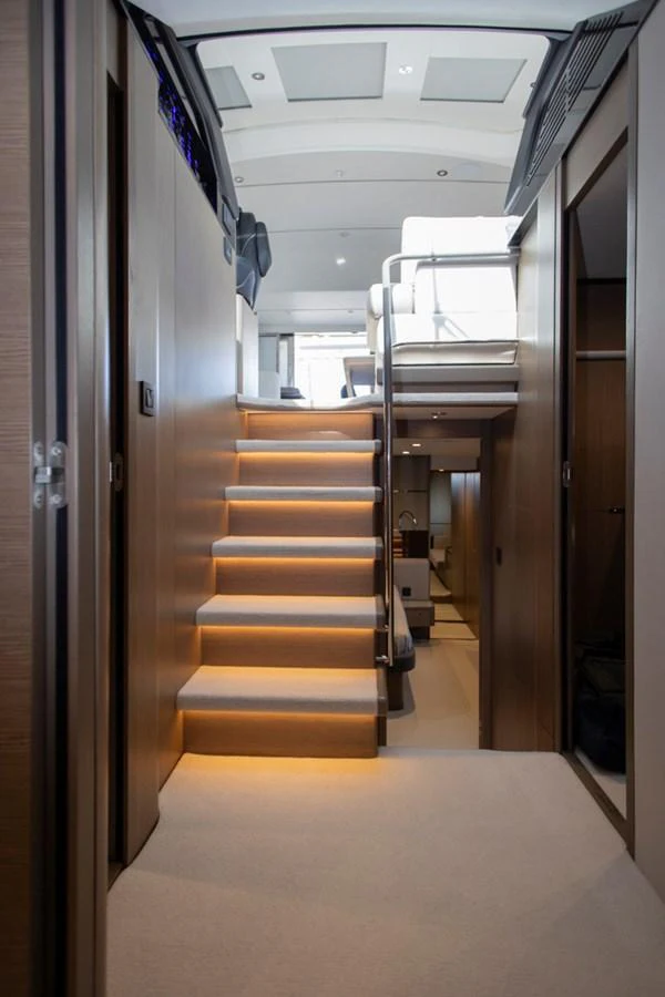A modern interior view featuring a staircase with ambient lighting leading to an upper deck. aboard BK ONE Yacht for Sale