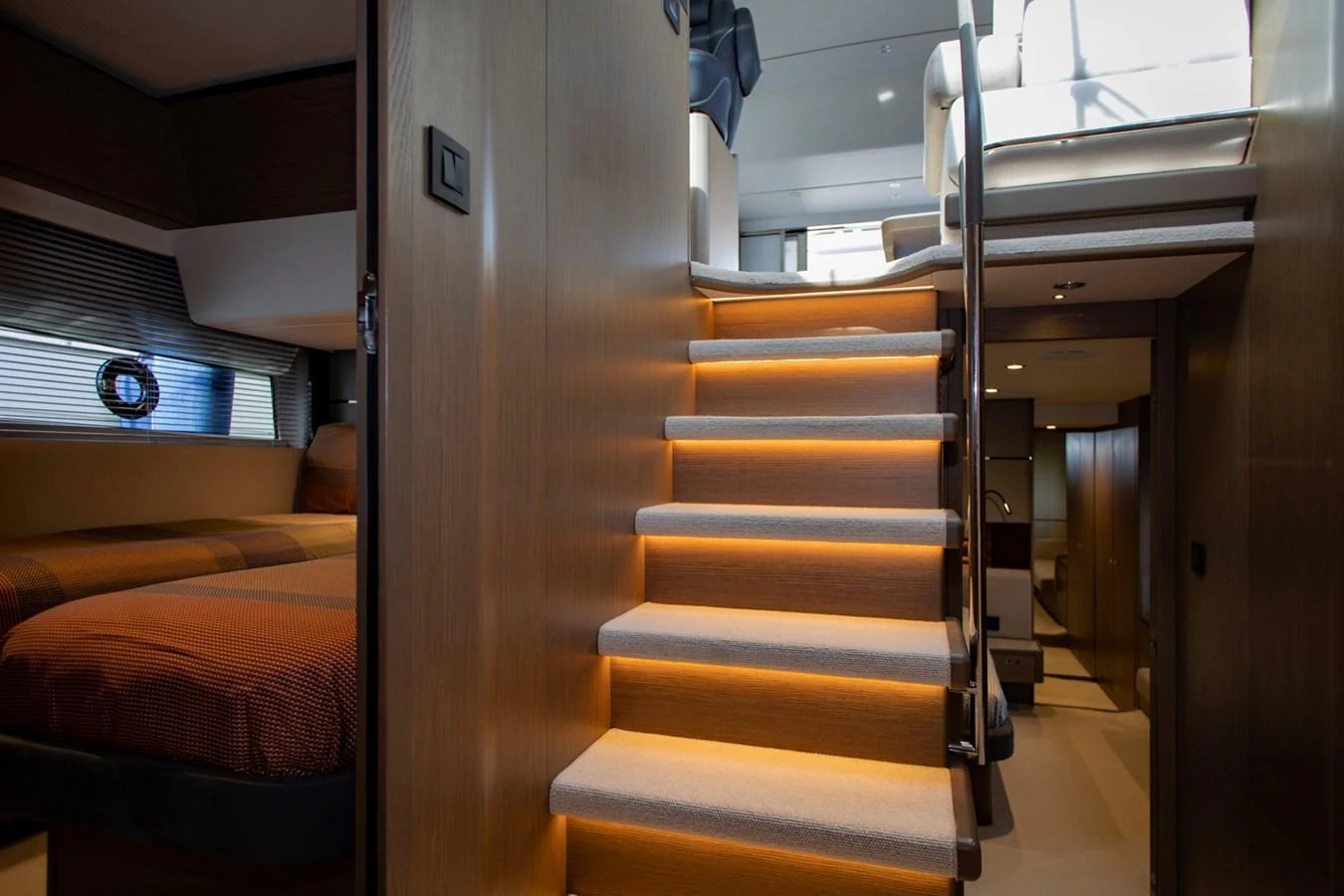 A well-lit staircase with modern design elements leads to the upper deck of the yacht. aboard BK ONE Yacht for Sale