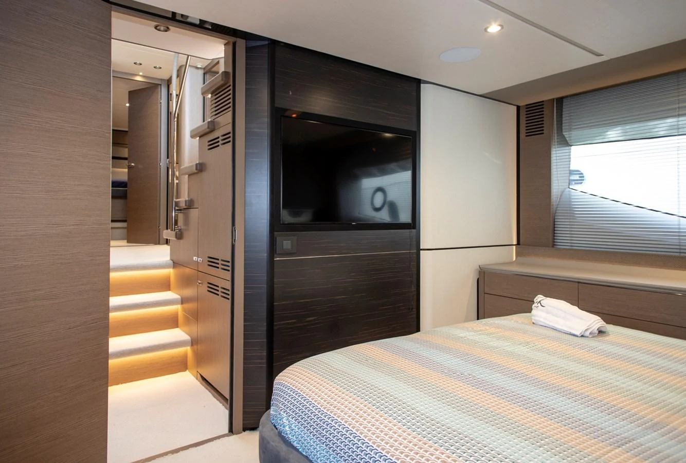 A luxurious stateroom featuring a large bed, modern decor, and a flat-screen TV. aboard BK ONE Yacht for Sale