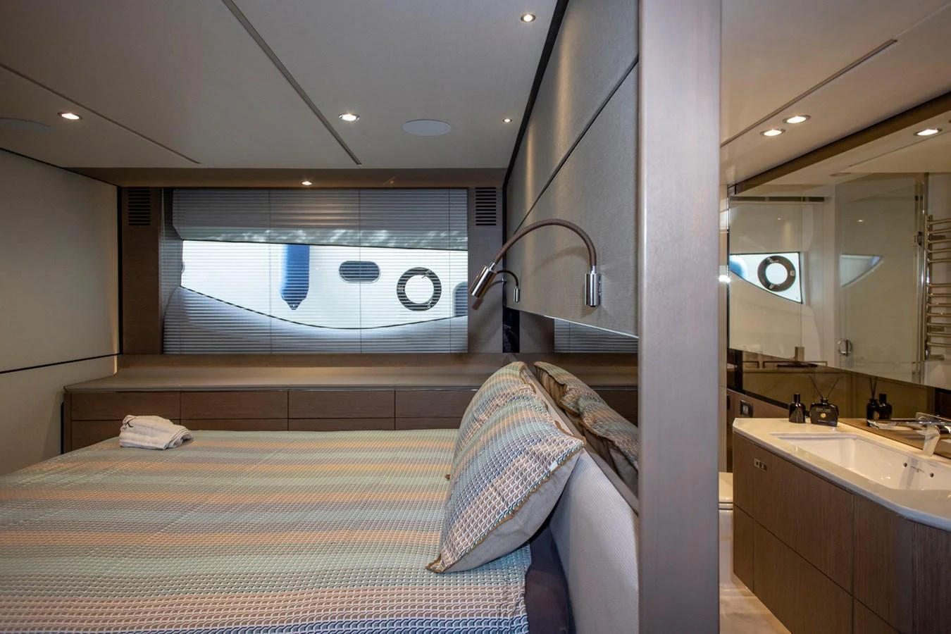 A luxurious stateroom featuring a comfortable bed and an ensuite bathroom. aboard BK ONE Yacht for Sale