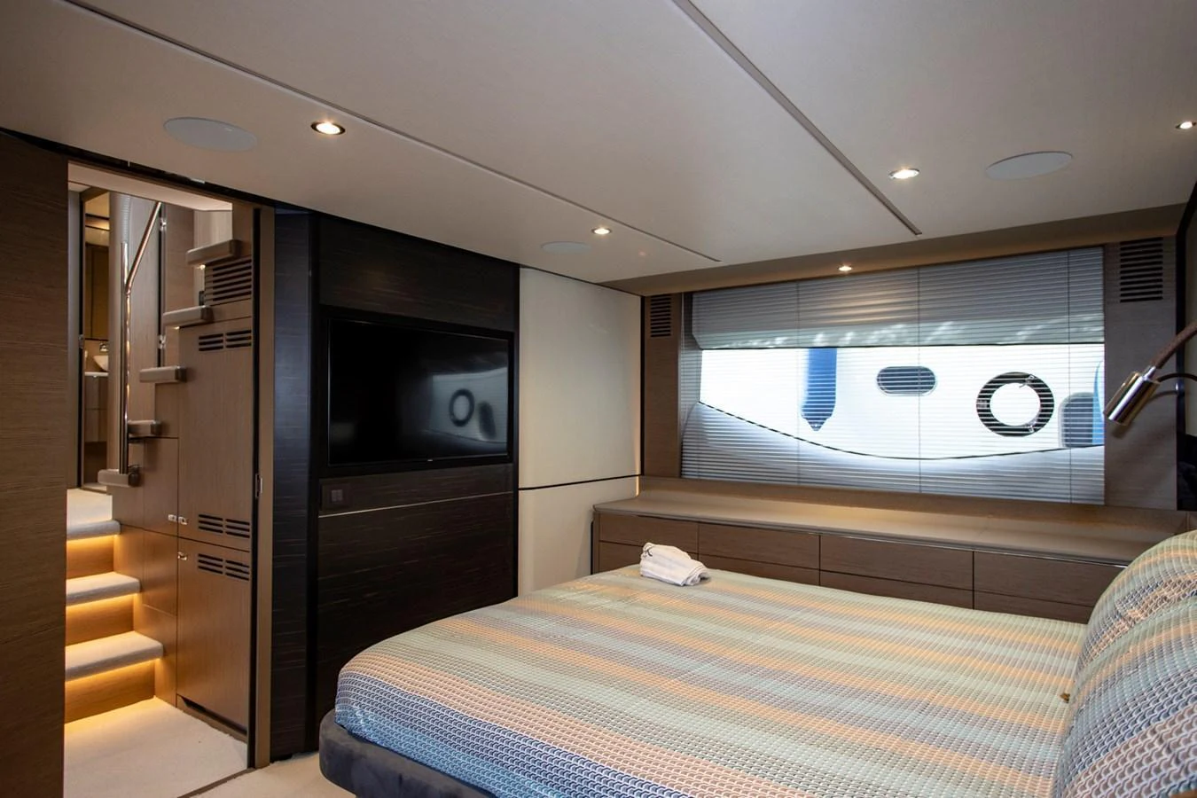 The stateroom features a comfortable bed, modern decor, and a flat-screen TV, creating a cozy and luxurious retreat. aboard BK ONE Yacht for Sale
