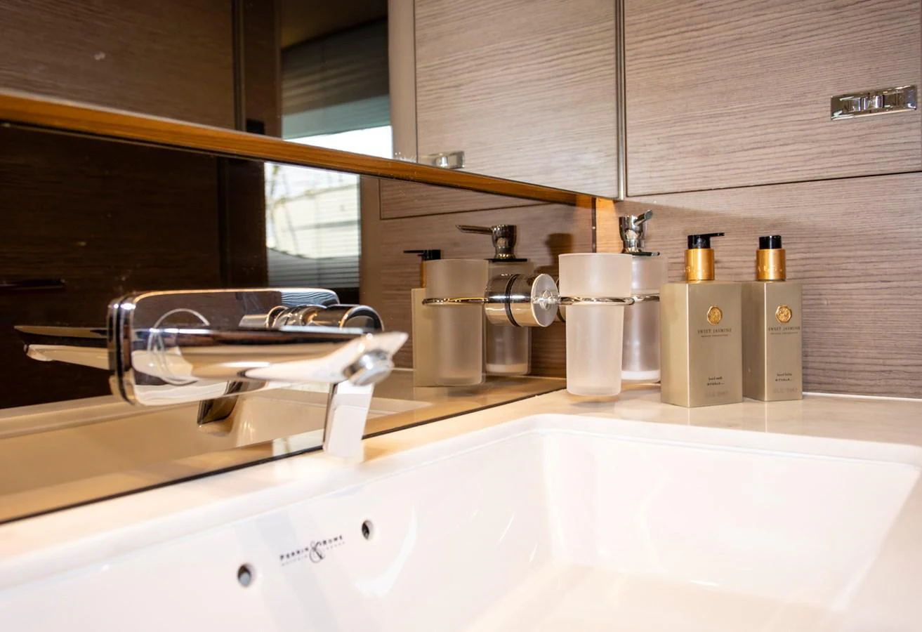 The yacht's bathroom features a modern sink with elegant fixtures and luxury toiletries. aboard BK ONE Yacht for Sale