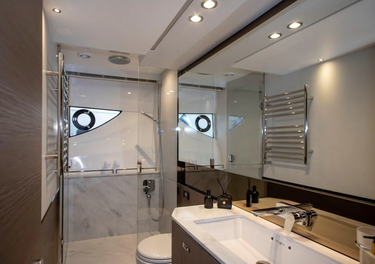 A modern yacht bathroom featuring sleek fixtures and ample lighting. aboard BK ONE Yacht for Sale